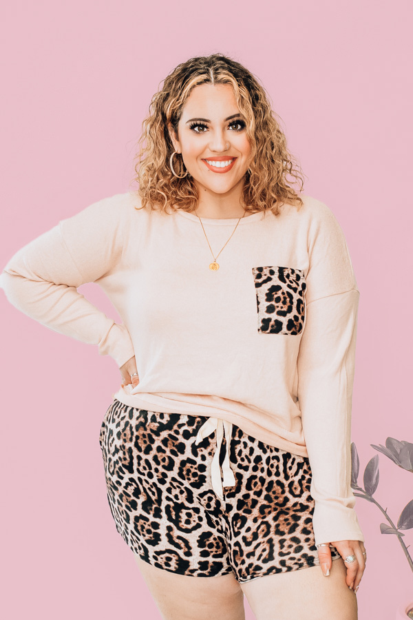 LONG SLEEVE FLEECE TOP AND SHORTS. NUDE COLOR TOP WITH LEOPARD POCKET DETAIL. LEOPARD SHORTS WITH ELASTIC WAIST AND NONFUNCTIONAL TIE. 77% RAYON 19% POLYESTER 4% SPANDEX. NIKKI IS SIZE 14, WEARING XL. DALLAN IS A SIZE 4, WEARING A SMALL.
