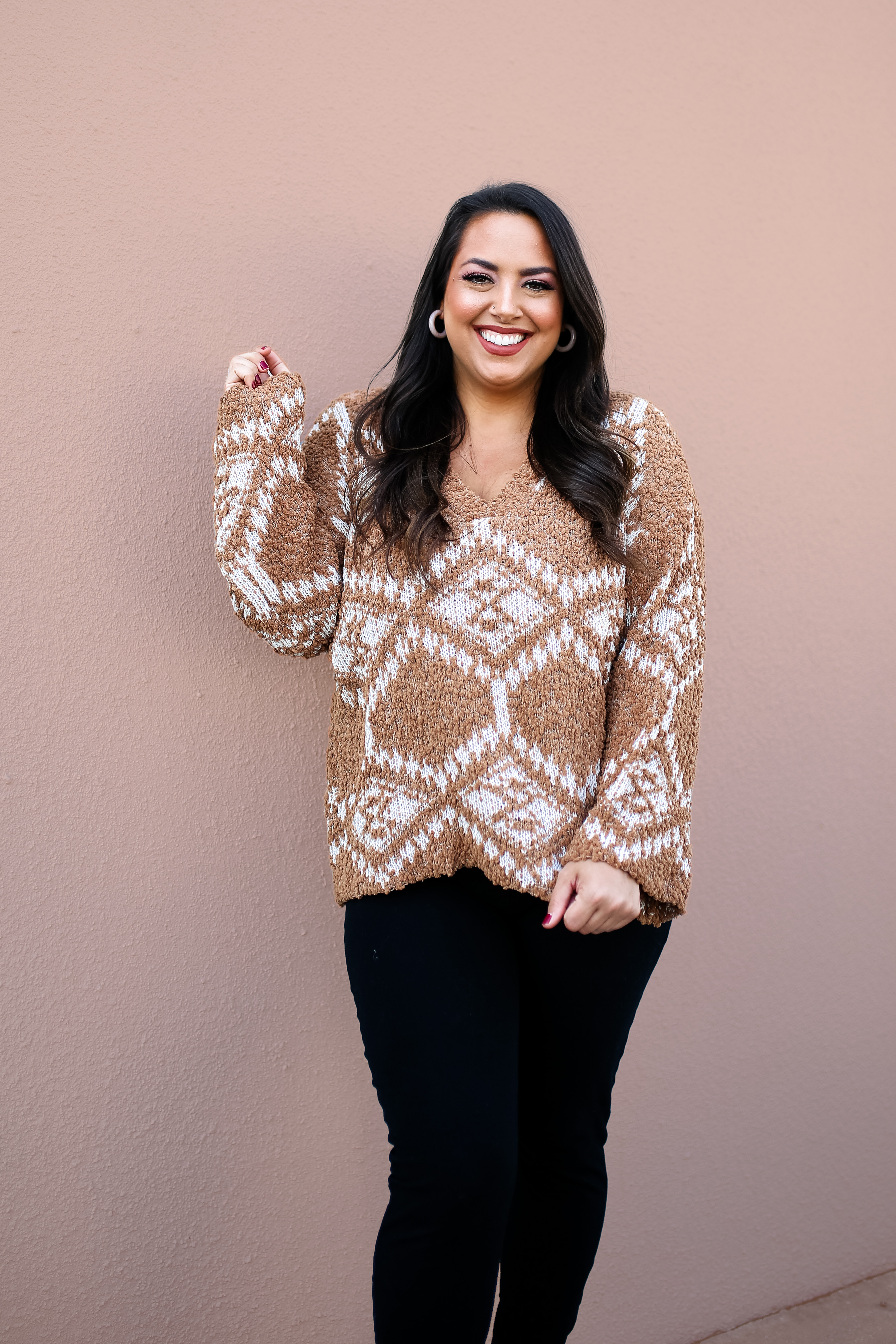 CAMEL AND WHITE KNIT SWEATER. SUPER SOFT AND STRETCHY, OVERSIZED FIT. V NECK, BELL SLEEVES. MINOR DISTRESSED DETAIL ON BOTTOM FRONT. 65% POLYESTER, 20% ACRYLIC, 15% NYLON. STEPHANIE IS 5’4 SIZE 4, WEARING SMALL. GABBY IS SIZE 10/12 WEARING LARGE.