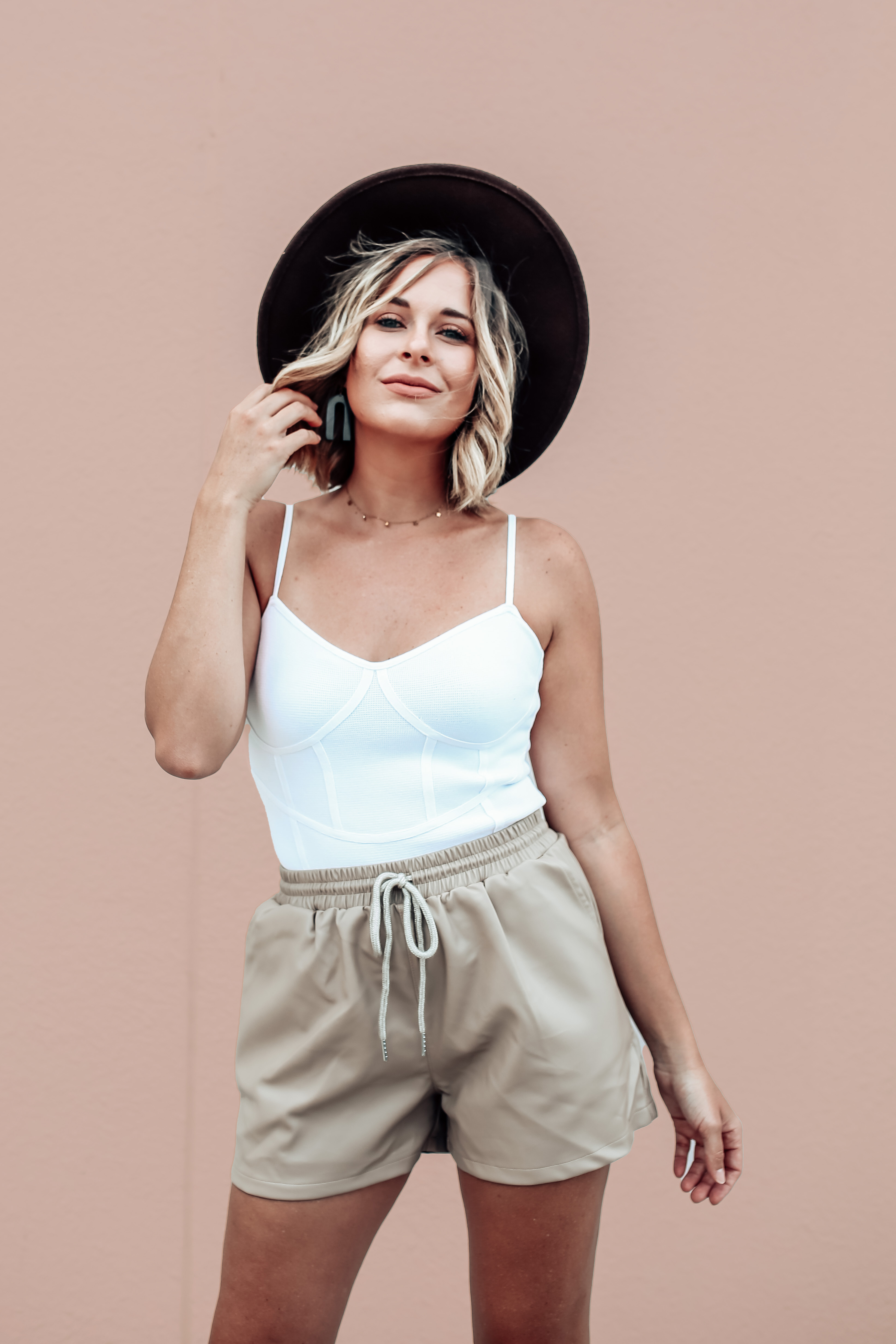 MAVERICK EXLCUSVE! TAN FAUX LEATHER SHORTS. ADJUSTABLE DRAWSTRING, ELASTIC WAIST. SIDE POCKETS. SOFT LINING INSIDE. 3 INCH INSEAM. 95% POLYESTER 5% SPANDEX. GABBY IS 5’8” A SIZE 12 AND 38DD WEARING AN XLARGE. AMANDA IS 5’6” A SIZE 2, WEARING A SMALL.