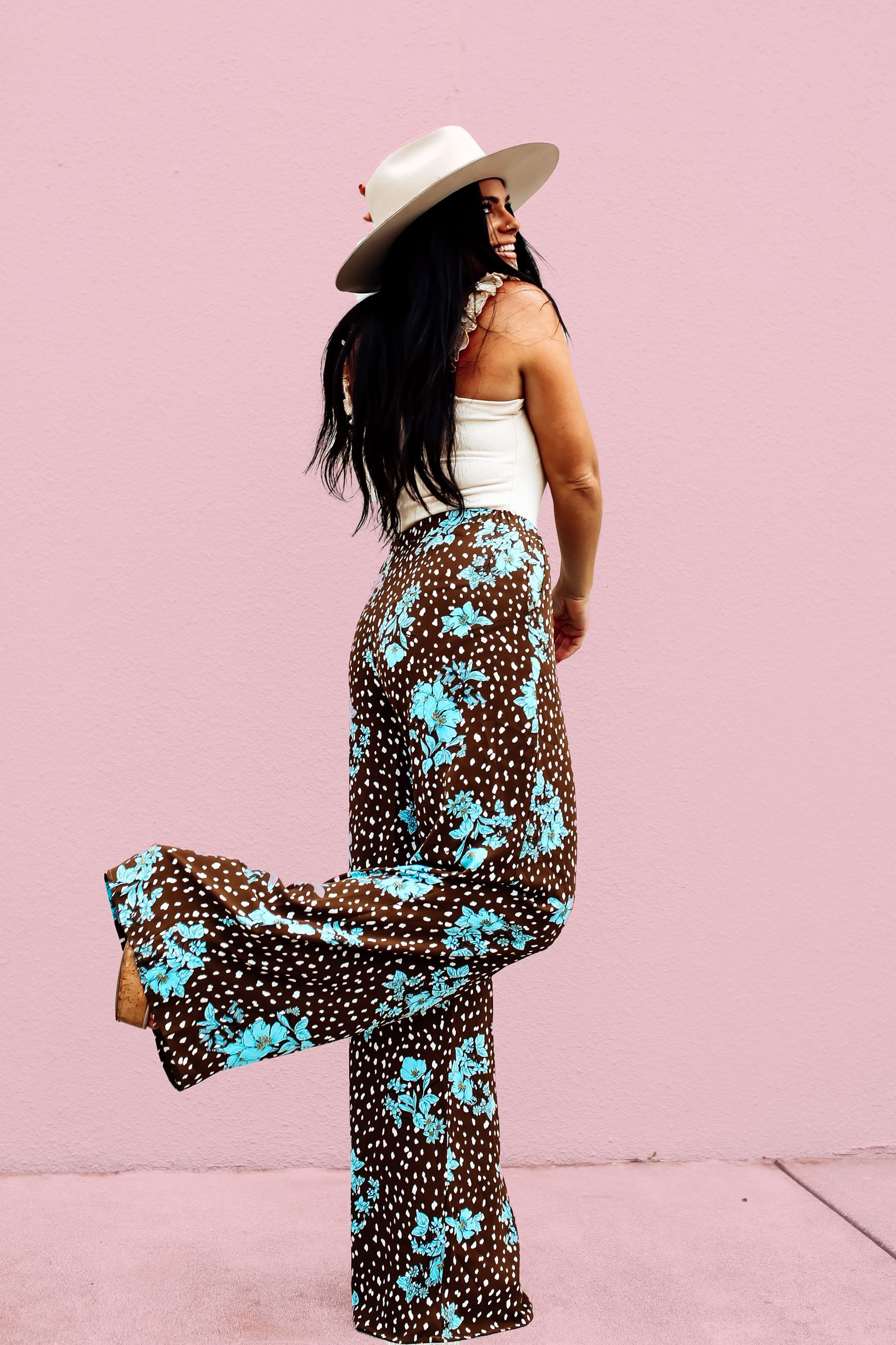 EXCLUSIVE TO MAVERICK . CHOCOLATE BROWN BACKGROUND WITH WHITE AND SKY BLUE FLORAL PATTERN. WIDE LEG, FLOWY PANT WITH ELASTIC WAIST. 34 INCH INSEAM. FUNCTIONAL SIDE POCKETS. 100% POLYESTER.