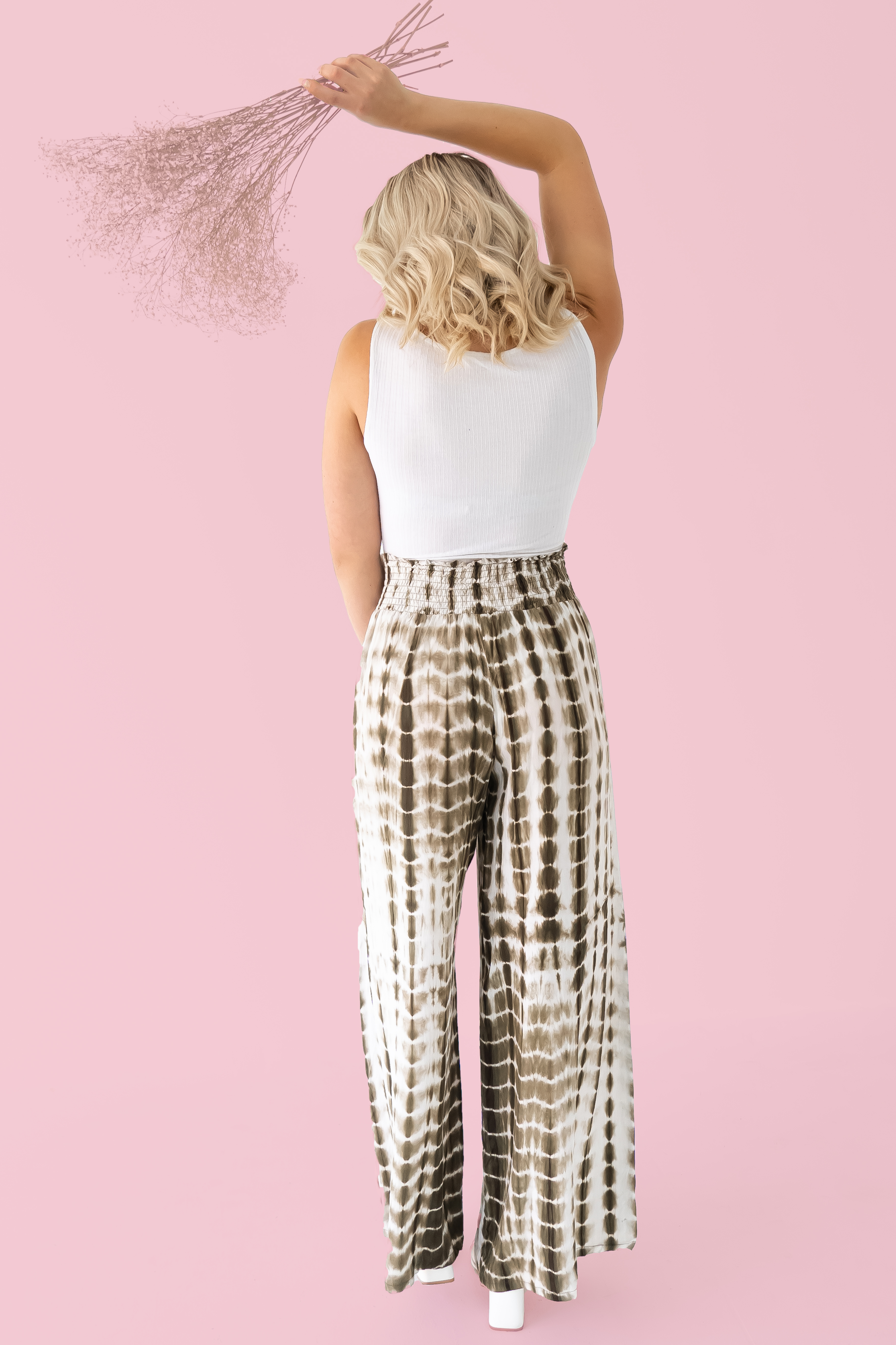 EXCLUSIVE TO MAVERICK! OLIVE AND WHITE TIE DYE, WIDE LEG PAINTS WITH ELASTIC WAIST. SAME MATERIAL AS THE ORIGINAL RUST/WHITE TIE DYE GABRIELLE, RUNS A TAD SMALLER. 100% POLYESTER. STEPHANIE IS 5’4” SIZE 4 WEARING A SMALL. SISSY IS A SIZE 10, WEARING AN XL