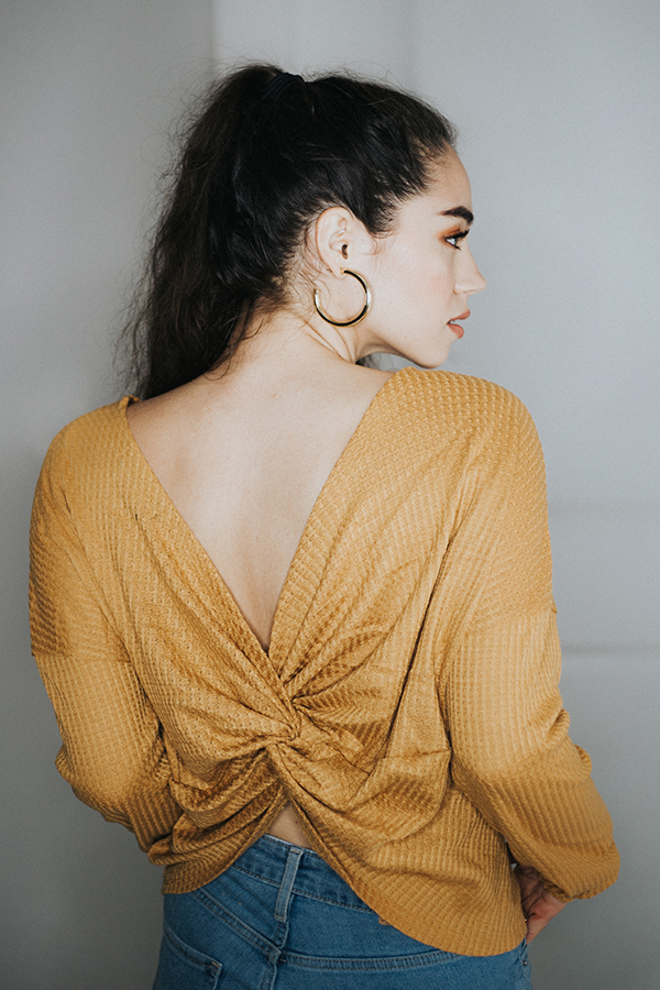 LIGHTWEIGHT THERMAL OPEN BACK TOP. THIS AMAZING STYLE OF THE SEASON COMES IN TWO COLORS, MUSTARD AND GREY! A TWIST, OPEN BACK AND A LITTLE SHORTER OF A WAIST MAKES FOR A CUTE STATEMENT PIECE.