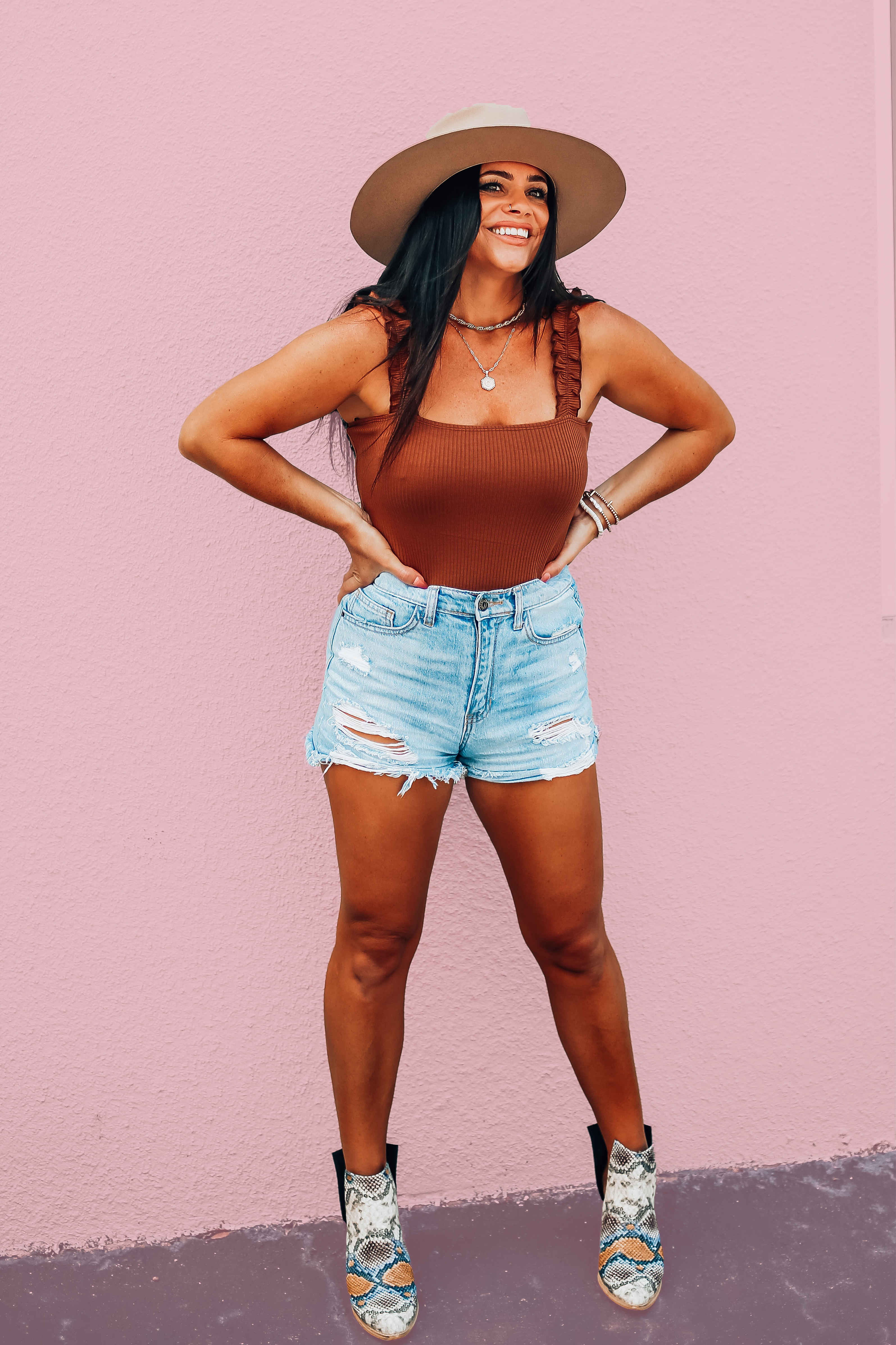 LOOSER FIT THAN OUR ORIGINAL AND BOTTOM IS A LITTLE FULLER COVERAGE. WALNUT BODYSUIT WITH RIBBING AND RUFFLED STRAPS. STRETCHY AND ELASTIC IN THE STRAPS. 95% POLYESTER, 5% SPANDEX.